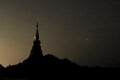 Silhouette of pagoda buddhism against night sky with copy space stars background. Royalty Free Stock Photo