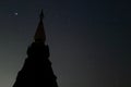 Silhouette of pagoda buddhism against night sky with copy space stars background. Royalty Free Stock Photo