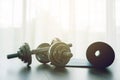 Dumbbells with blue yoga mat on wood floor