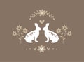 Silhouette of pair of easter bunnies on brown background