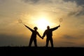 Silhouette pair of a man and a woman as husband and wife in the sky yellow sunset