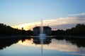 The silhouette of the Palais and the pond in the park \