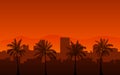 Silhouette palm tree on beach and cityscape under sunset sky background Royalty Free Stock Photo