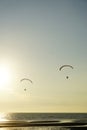 Silhouette of para gliding at sunset sky with sea background Royalty Free Stock Photo