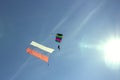 Silhouette of a parachutist flying in the sky to the sun Royalty Free Stock Photo