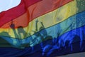 silhouette of a parade of gays and lesbians with a rainbow flag - symbol of love and tolerance