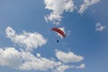 Silhouette of paraglide flying in the sky with clouds in a light of sunrise. Ukrainian Carpathian valley