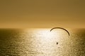 Silhouette of paraglider flying at sunset Royalty Free Stock Photo