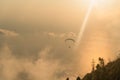 Silhouette of paraglider soaring over sea at sunset light Royalty Free Stock Photo