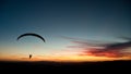 Silhouette of paraglider at sunset.