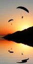 Silhouette paragliders in coastal sunset landscape