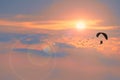 silhouette paramotor flying follow birds and sunset cloud background with fog over on the top mountain Royalty Free Stock Photo