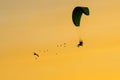 Silhouette Paramotor, Parachute, Paraglide flying in the sunset Royalty Free Stock Photo