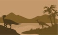 Silhouette of parasaurolophus in lake