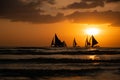 Silhouette Paraw sailing boats under orange sunset Royalty Free Stock Photo
