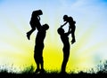 Silhouette of parents and children having fun spending time