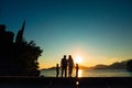 Silhouette of parents and two children at sea at sunset. Montene