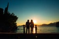 Silhouette of parents and two children at sea at sunset. Montene