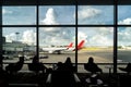 Silhouette of passenger waiting flight for travel in lounge at a Royalty Free Stock Photo