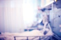Silhouette of patient lying in the bed in the hospital emergency care unit, defocused background