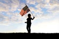 Silhouette of Patriotic Little Girl Child Waving American Flag Royalty Free Stock Photo