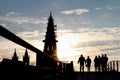 Silhouette of pedestrians on bridge in ront of mÃÂ¼nster Royalty Free Stock Photo