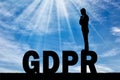 Silhouette pensive man standing on the word GDPR