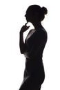 Silhouette of a pensive woman with the hand at the chin on a white isolated background, girl make a decision Royalty Free Stock Photo