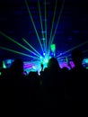 Blurred crowd at concert : People crowd happy and cheeringÃ¢â¬â¹ in front of colorful stage with bright laser light beam.Ã¢â¬â¹ Royalty Free Stock Photo