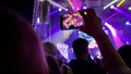 silhouette of people enjoying and filming a concert Royalty Free Stock Photo