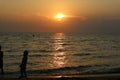 silhouette one kid play on sea sunset