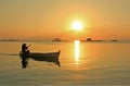 silhouette of people or fishermen rowing a traditional fishermen\'s boat in the sunset in Karimun Jawa, Indonesia, 2013. Royalty Free Stock Photo