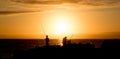 Silhouette of people fishing on a boat in the sea during the sunset Royalty Free Stock Photo