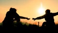 Silhouette of people helping each other hand by hand Royalty Free Stock Photo