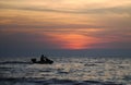 Silhouette people on jetski in sunset time Royalty Free Stock Photo
