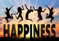 Silhouette people jumping over the word happiness