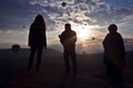 Silhouette of people looking at morning flight of passenger ball