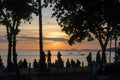 Silhouette of people looking at the sunset in the sea, in Ao Nang, Thailand