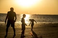 Silhouette people playing on the beach.