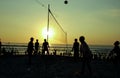 Silhouette people playing volleyball