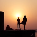Silhouette of people practicing yoga Royalty Free Stock Photo