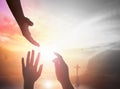 Silhouette people raising hands over blurred the cross on beautiful golden autumn sky sunset background Royalty Free Stock Photo