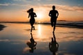 Silhouette of people running on a beach at sunset. Royalty Free Stock Photo