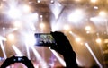 Silhouette of people shooting the concert event with mobile phones Royalty Free Stock Photo