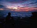 Silhouette People Sit on the cliff with beautiful sunrise sky on on Khao Luang mountain in Ramkhamhaeng National Park Royalty Free Stock Photo