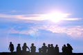 Silhouette people sitting on the floor in the morning sky blue cloud and birds flying Royalty Free Stock Photo