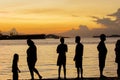 Silhouette of people standing at harbor port against beautiful sunset sky Royalty Free Stock Photo