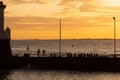 Silhouette of people, at sunset, on the Porto da Barra pier