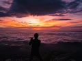 Silhouette People Take a Selfie on the cliff with beautiful sunrise sky on Khao Luang mountain Royalty Free Stock Photo