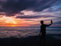 Silhouette People Take a Selfie on the cliff with beautiful sunrise sky on Khao Luang mountain Royalty Free Stock Photo